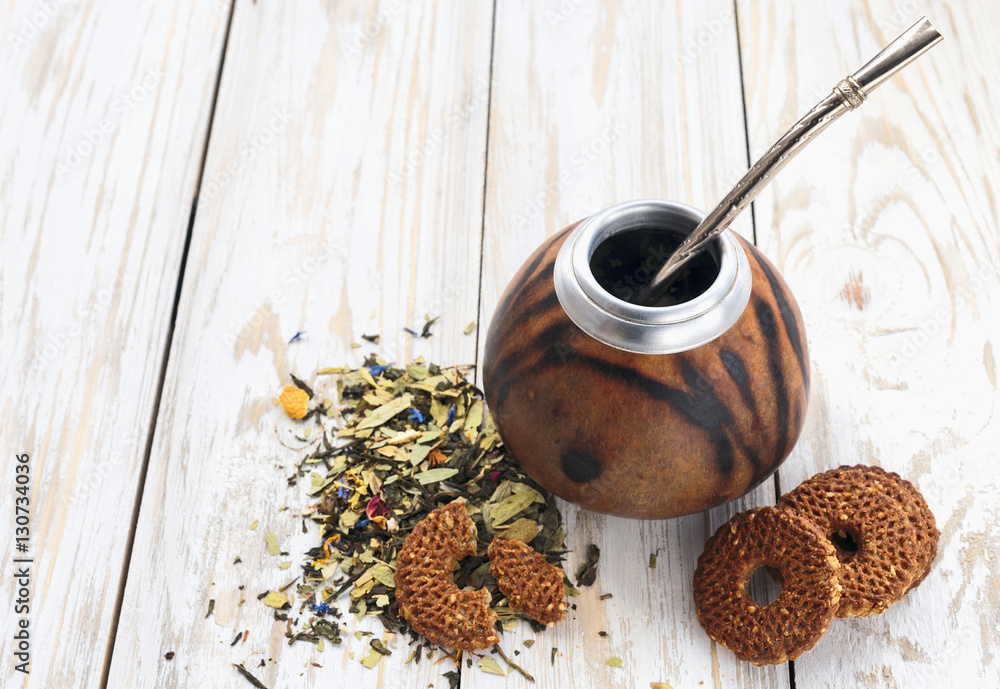 Yerba mate tea in a wooden calabash and cookies Yerba mate tea in a wooden calabash and cookies