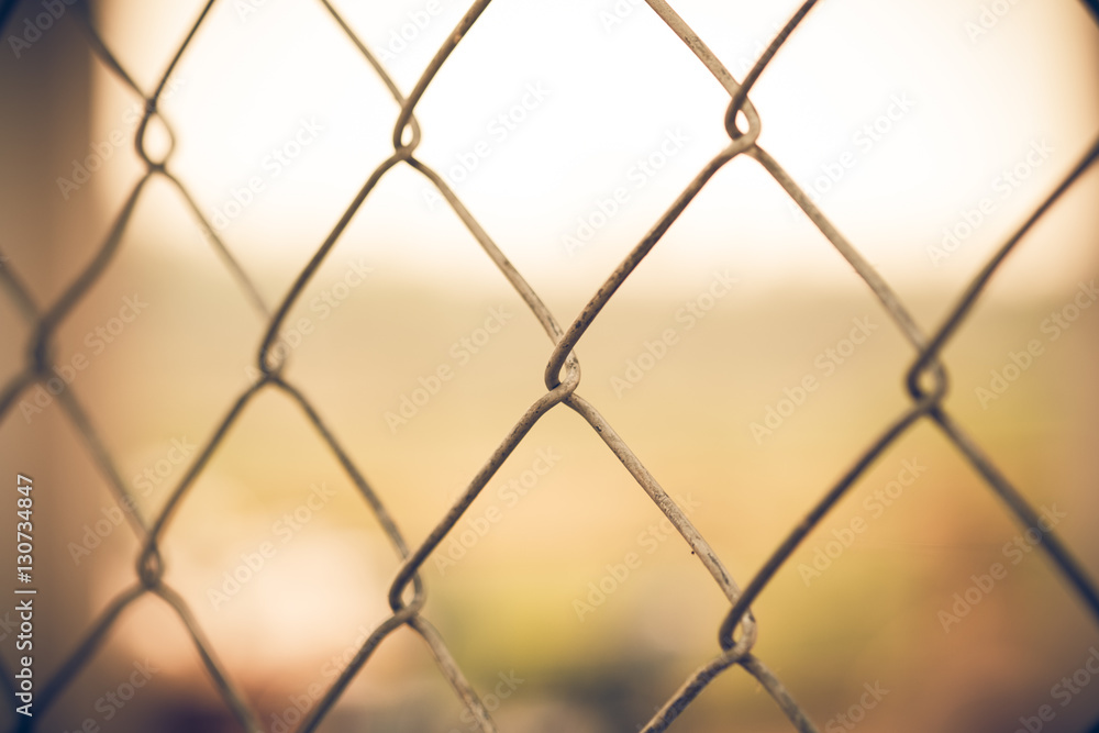 Old wire fence with sunset for background/texture. Old wire fence with sunset for background/texture.