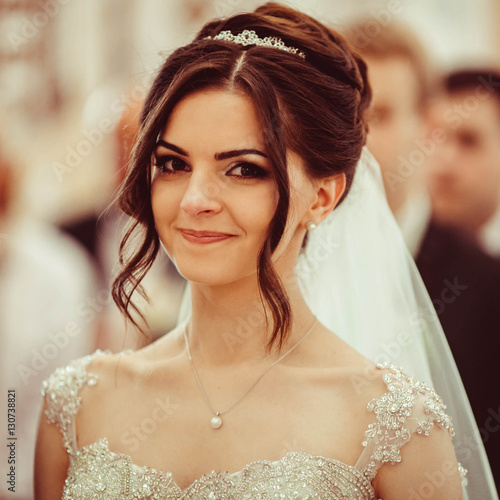 beautiful and young bride standing at wedding ceremony