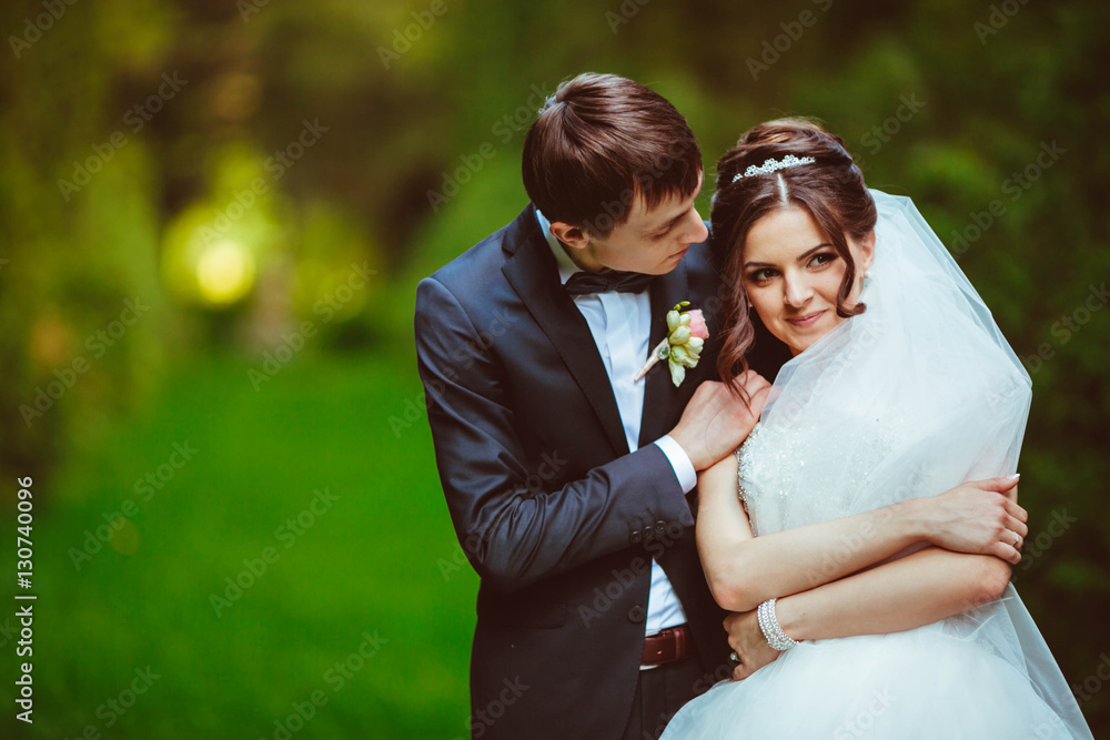 nice portrait of handsome and young groom and his beautiful brid