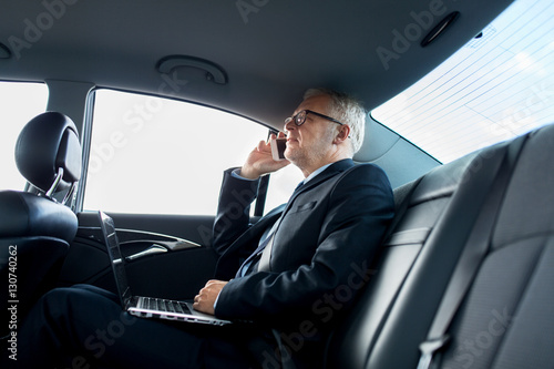 senior businessman calling on smartphone in car © Syda Productions