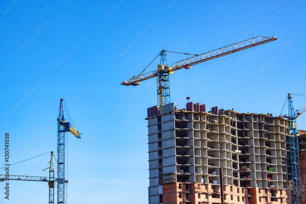 close up picture of building in progress with tower cranes