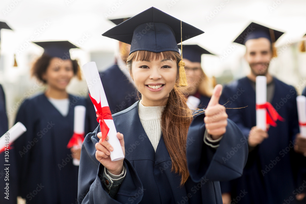 happy students with diplomas showing thumbs up happy students with diplomas showing thumbs up
