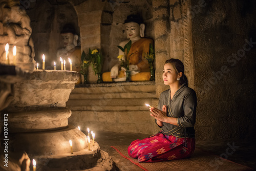 Beautiful Asian burma women making offerings of incense candles