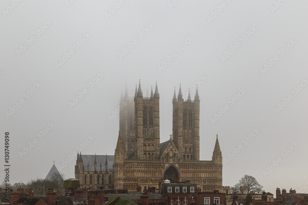 High view of Lincoln Cathedral from castle wall, in fog.
