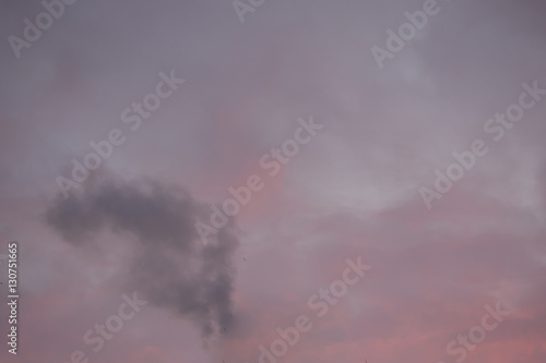 Winter sky at the clouds and sunset with smoke © golubka57