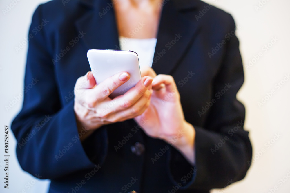 Woman hands holding white mobile phone. Closeup. Woman hands holding white mobile phone. Closeup.