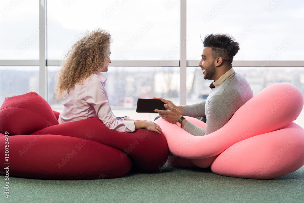 Businesspeople Couple In Coworking Center Business Team Coworkers Using Cell Smart Phone Sitting in front Big Panoramic Window Modern Office