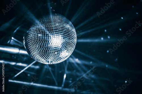 Disco ball with bright rays, blue toned