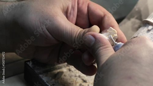 Close-up of ceramet implant creature process at laboratory. Technician creating a model of jaw with gipsum for create ceramet implant. photo