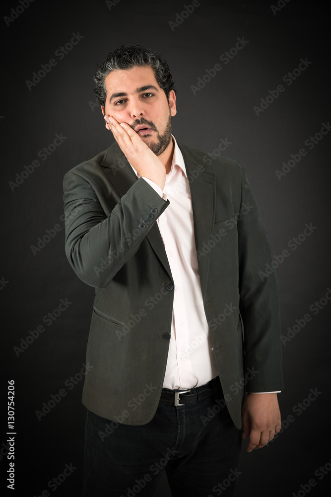 Handsome man doing different expressions in different sets of clothes: toothache Handsome man doing different expressions in different sets of clothes: toothache