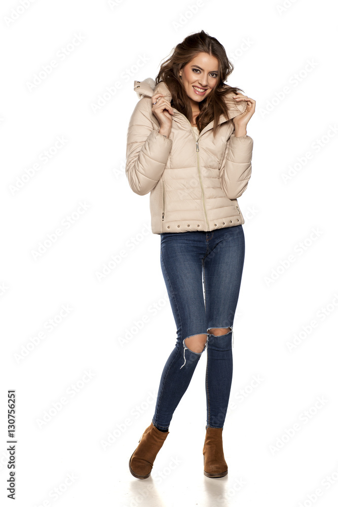 young woman in a winter jacket and jeans on the white background young woman in a winter jacket and jeans on the white background