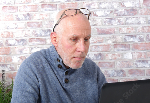Portrait of a handsome mature man using laptop