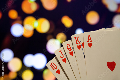 Royal flush poker cards combination on blurred background casino luck fortune photo