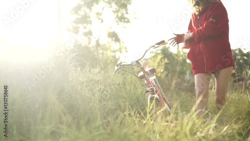woman with bicycles in the field