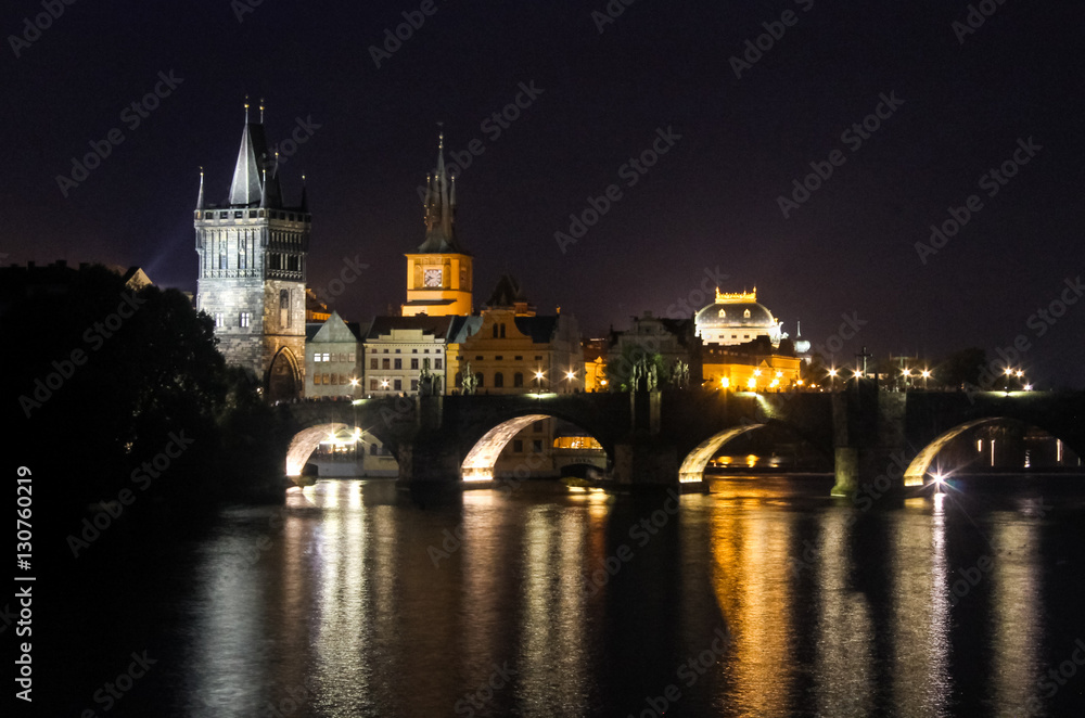 Charles Bridge old city of Czech Republic capital Prague at night reflection of lights in river