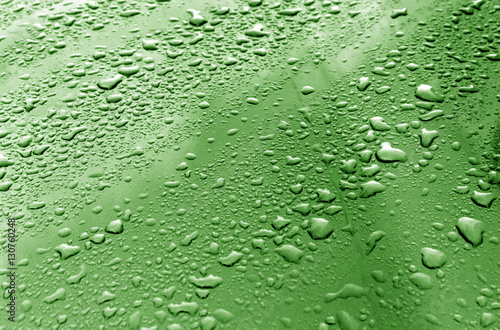 Rain drops on green metal surface.