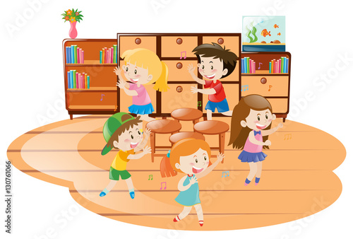 Children playing music chairs in classroom