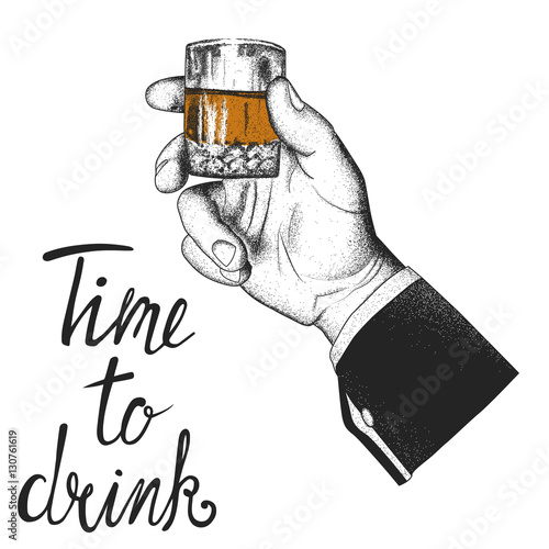Male hand holding a glass of whiskey