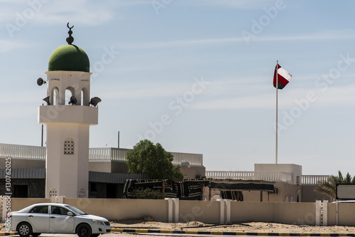Mosque tower ubar Dhofar mountain region Oman flag salalah photo