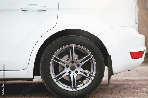tyres and wheels on the white car. © kucheruk