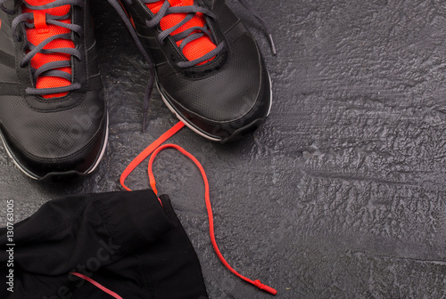 Sport flat lay composition with sneackers on black background. Concept special for healthy lifestyle and sport. Fitness equipment photo