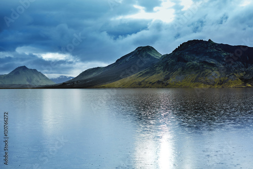 Lake coast with mountain reflection at the sunrise, Iceland. treking in Iceland. Travel concept.