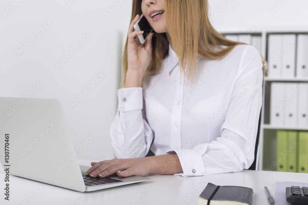 Close up of a blond girl on her phone in office Close up of a blond girl on her phone in office