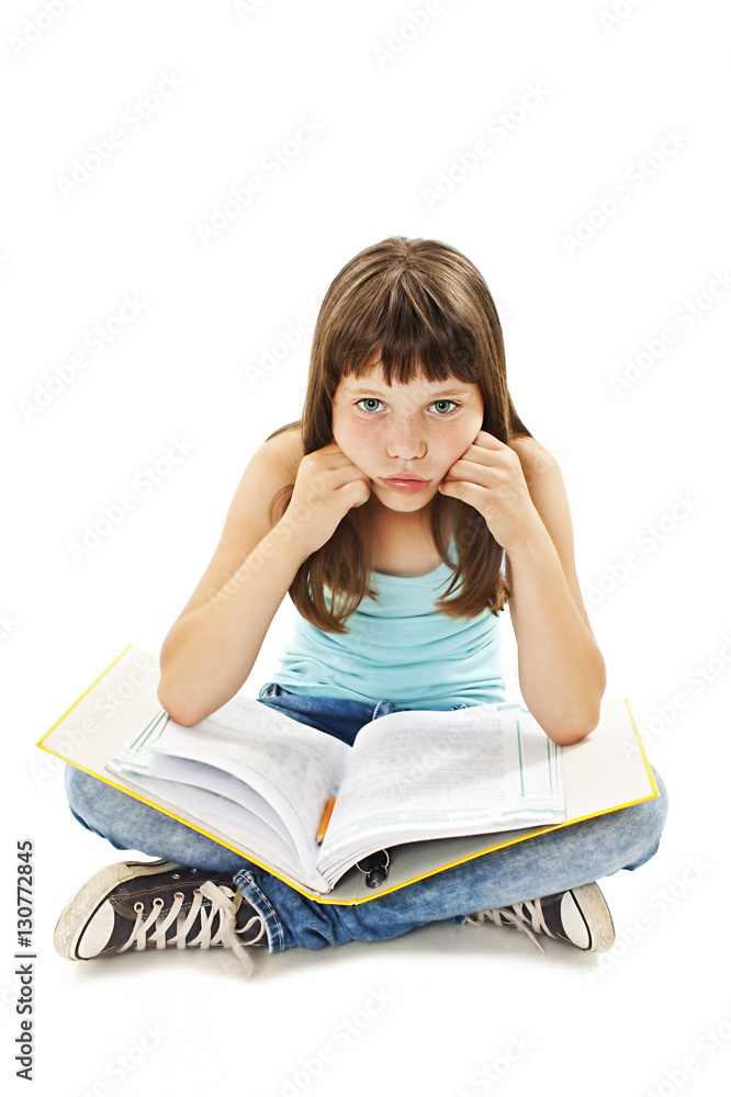 Tired school girl, frustrated and overwhelmed by studying homework. Young girl sitting down on floor isolated on white background.
