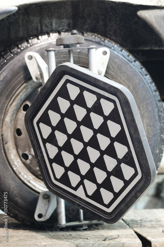 Close up target of wheel alignment equipment on a car's wheel photo