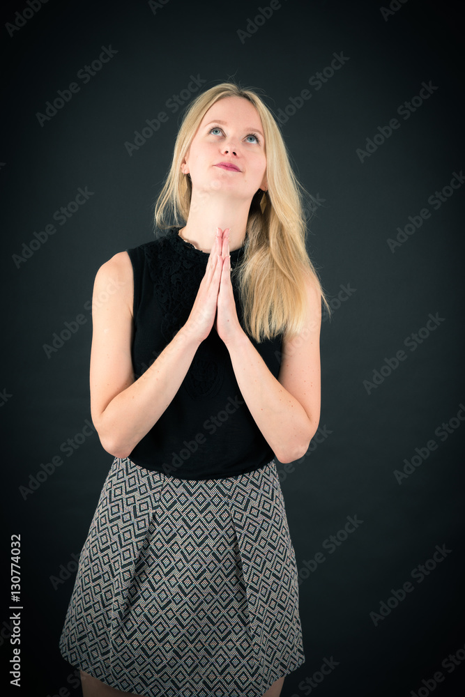 Beautiful woman doing different expressions in different sets of clothes: prayer