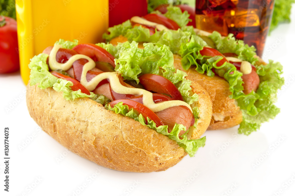 Hotdogs with lettuce,tomatoes and cucumber on white background Hotdogs with lettuce,tomatoes and cucumber on white background