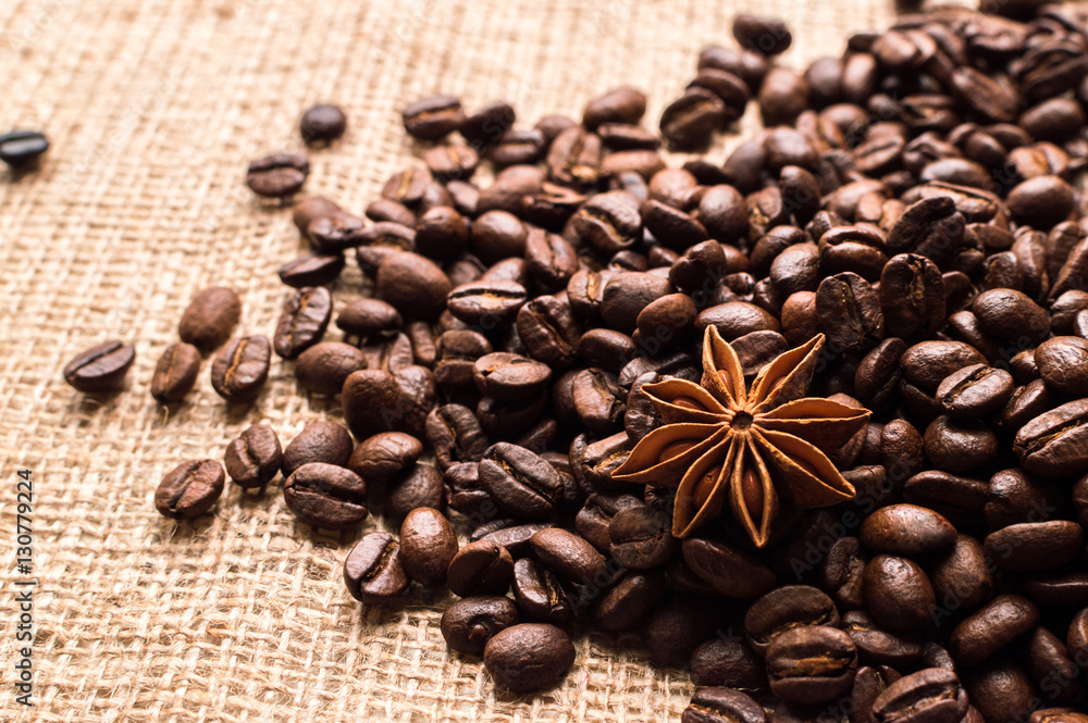 Coffee beans and badian on the sackcloth background Coffee beans and badian on the sackcloth background