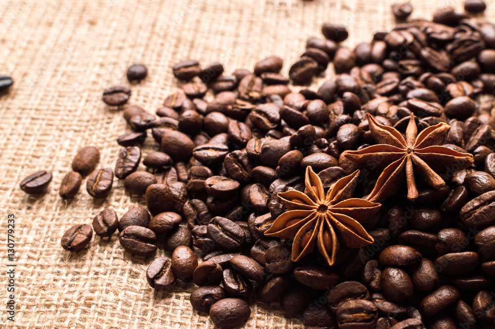 Coffee beans and badian on the sackcloth background Coffee beans and badian on the sackcloth background