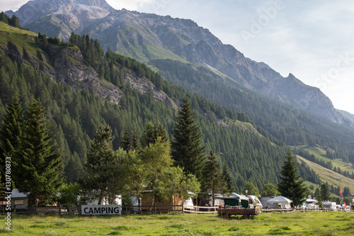 Cars and campervans in an outdoor mountain camping site staying here overnight