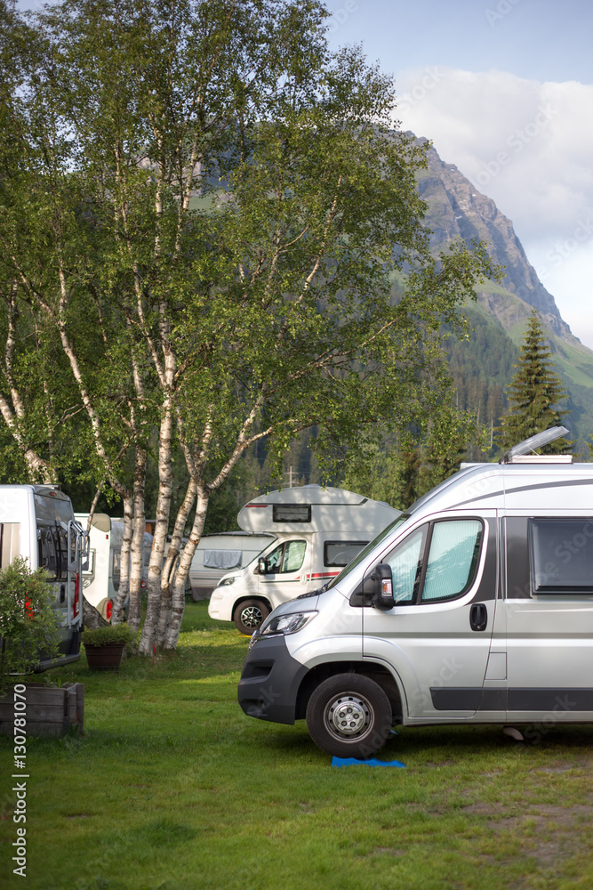 Cars and campervans in an outdoor mountain camping site staying here overnight