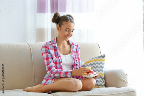 Cute girl with macaroons at...