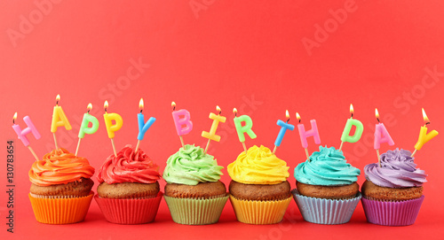 Happy birthday cupcakes on red background