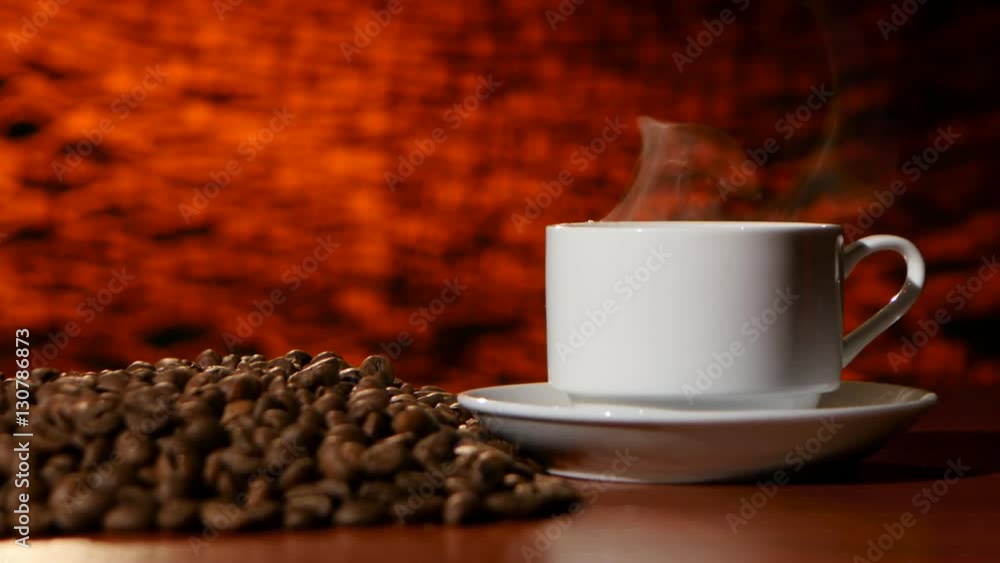 Cup on a white saucer of hot coffee on the aroma spreads room Cup on a white saucer of hot coffee on the aroma spreads room