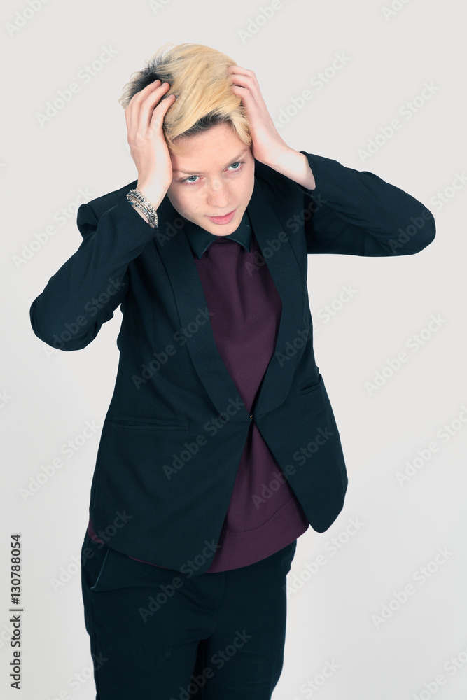 Beautiful woman doing different expressions in different sets of clothes: headache Beautiful woman doing different expressions in different sets of clothes: headache