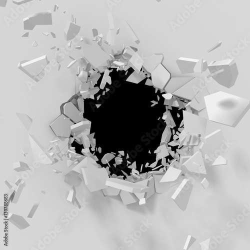 Fototapeta Naklejka Na Ścianę i Meble -  Cracked explosion hole with fragments in white wall
