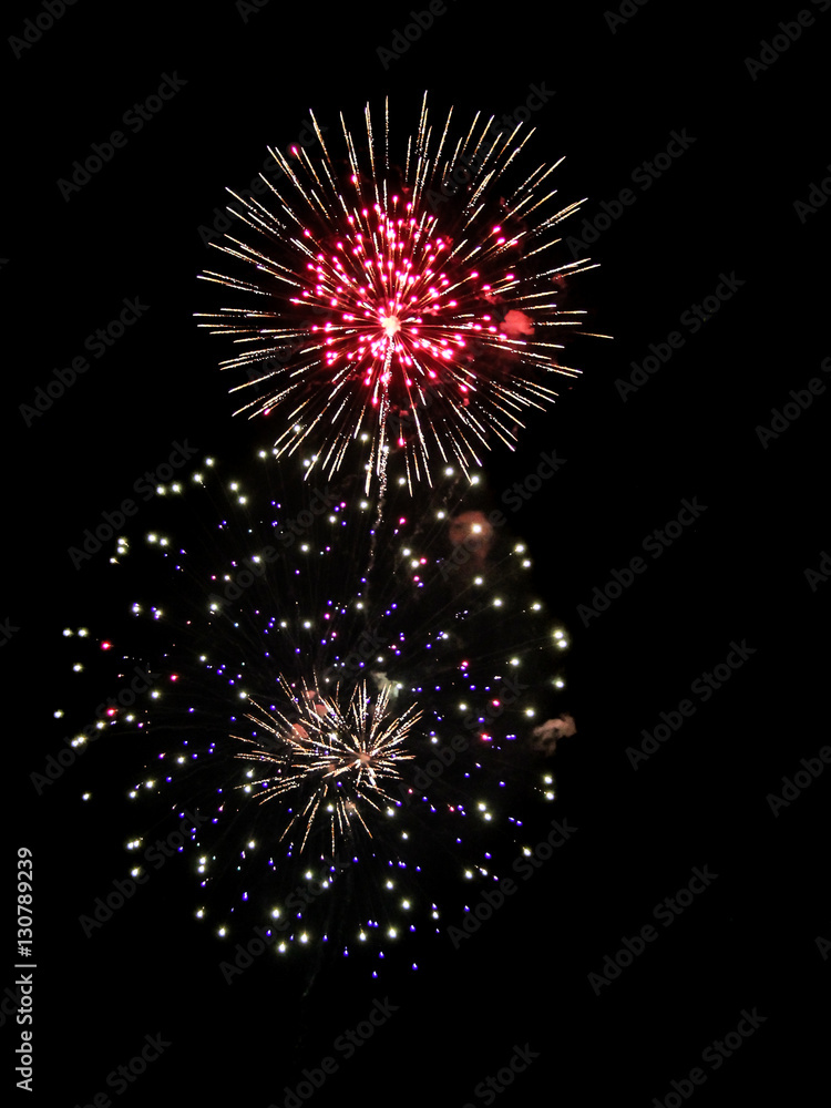 Fototapeta premium Brightly Colorful Fireworks isolated black background. New Year celebration fireworks.
