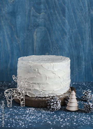 Triple chocolate layer cake. Milk, white and dark chocolate cake on wooden background. Christmas background photo