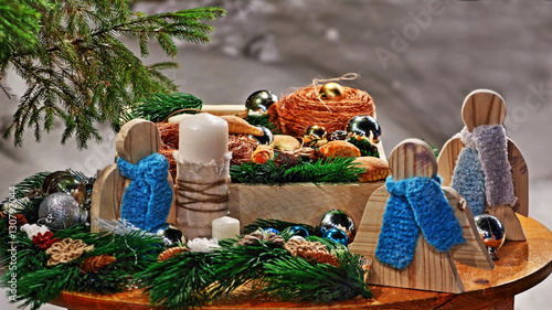 Christmassy still-life with lots of toys on a wooden board, on a background of snow and fir