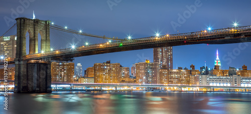 Panoramic view of Brooklyn Bridge at night with lights  New York