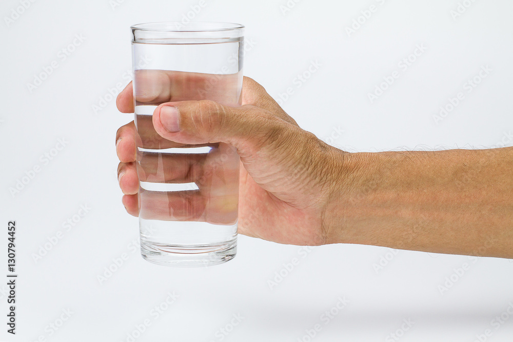 Man hand holding glass of full water on white background Man hand holding glass of full water on white background