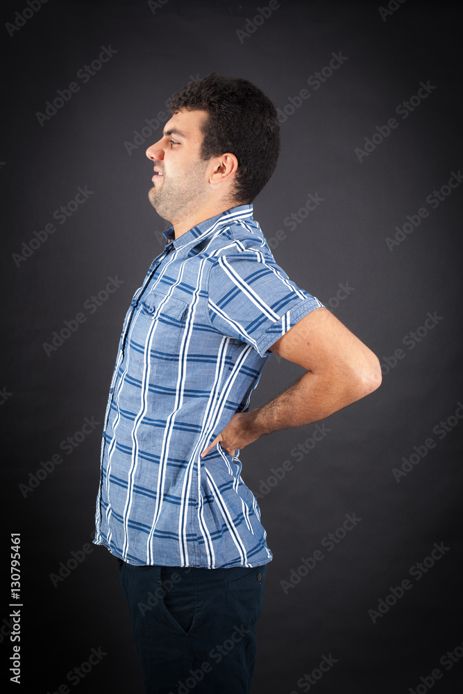 Handsome man doing different expressions in different sets of clothes: backache Handsome man doing different expressions in different sets of clothes: backache
