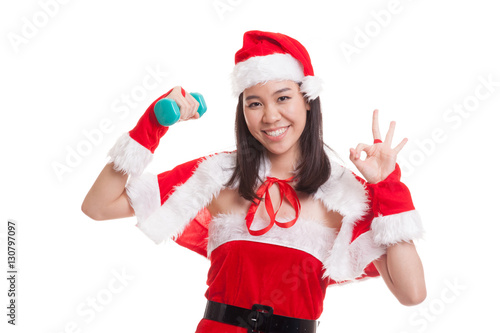Asian Christmas Santa Claus girl show Ok with red dumbbell.