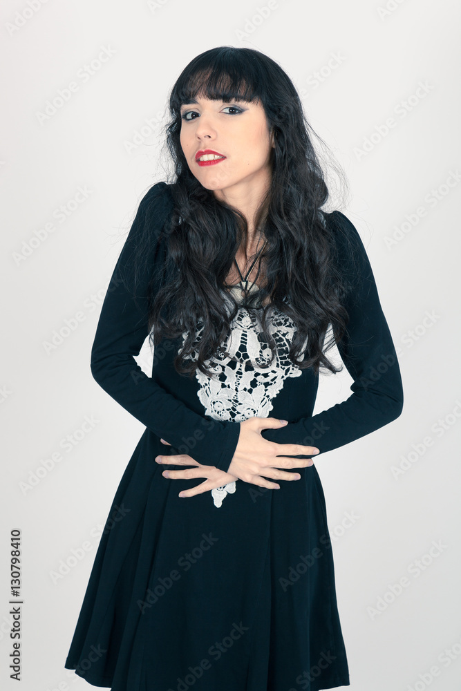 Beautiful woman doing different expressions in different sets of clothes: stomachache Beautiful woman doing different expressions in different sets of clothes: stomachache