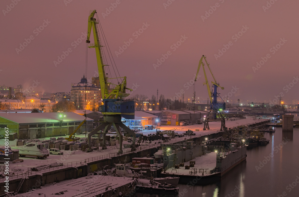 KYIV, UKRAINE-05 December 2016: Evening city landscape. River port and Pedestrian bridge